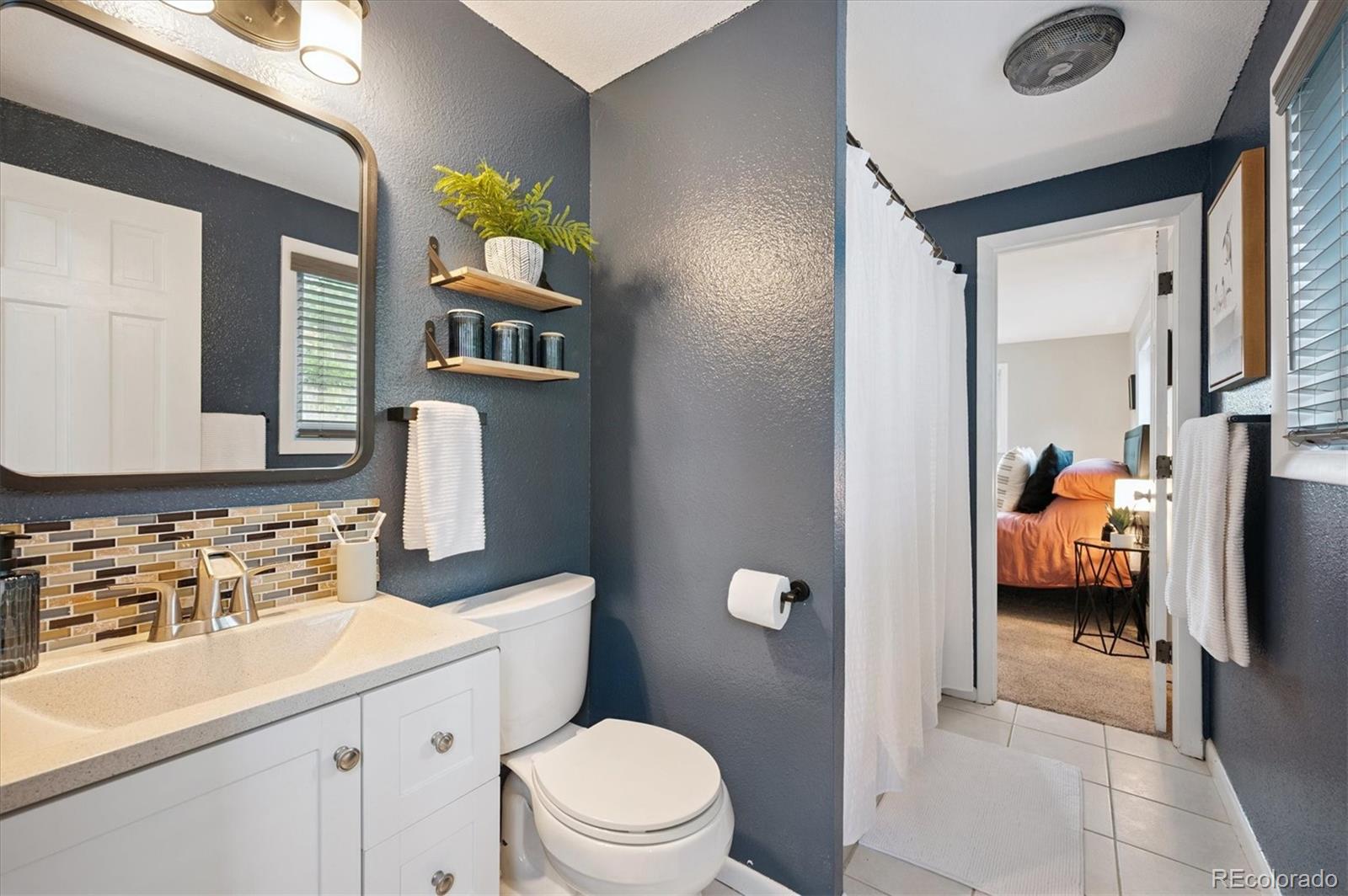 9189 Fallen Rock Road Conifer, CO 80433 - Photo 15 of 47 a en suite bathroom with a toilet sink and mirror