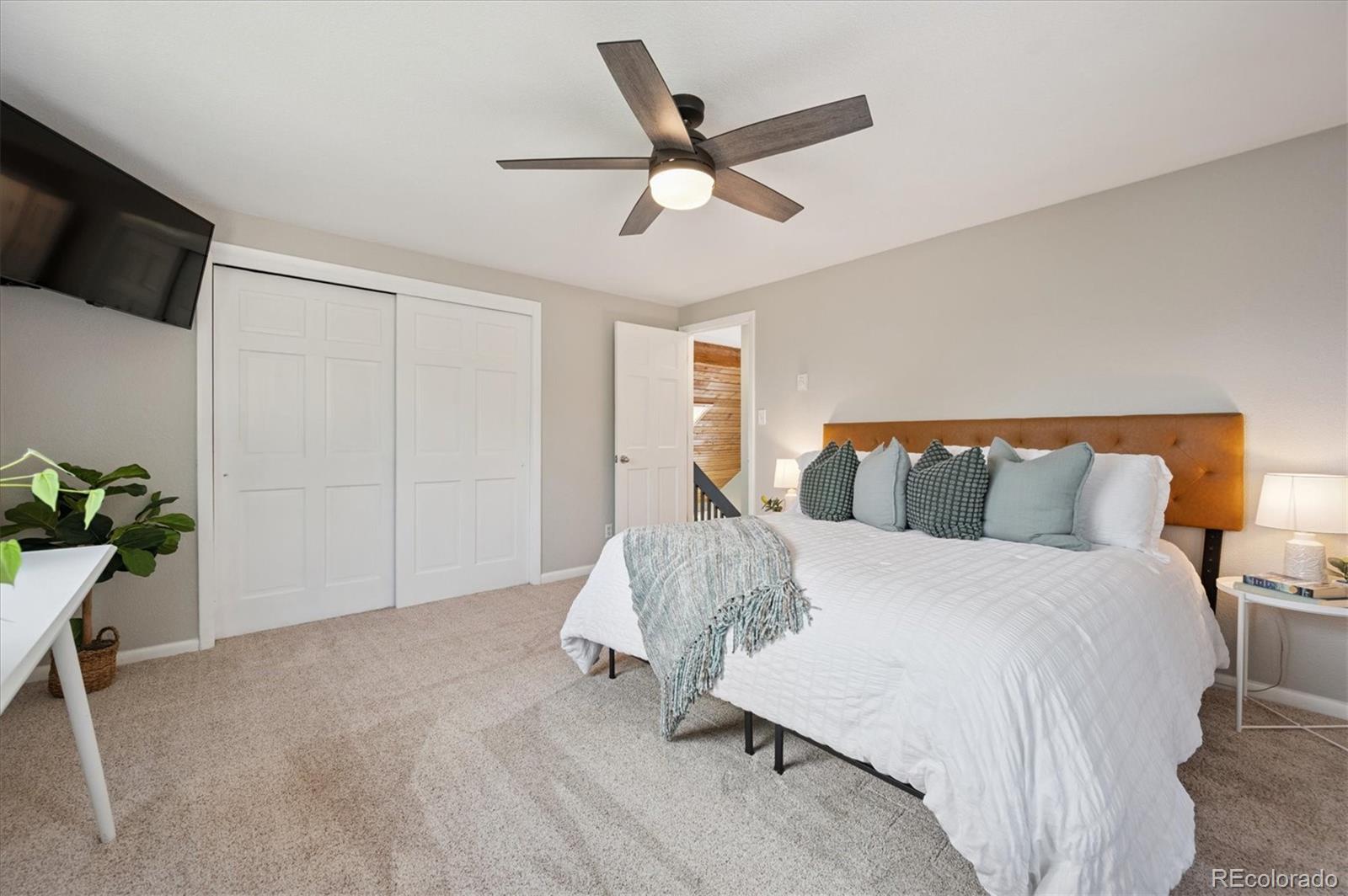 9189 Fallen Rock Road Conifer, CO 80433 - Photo 16 of 47 a bed room with a bed and a potted plant