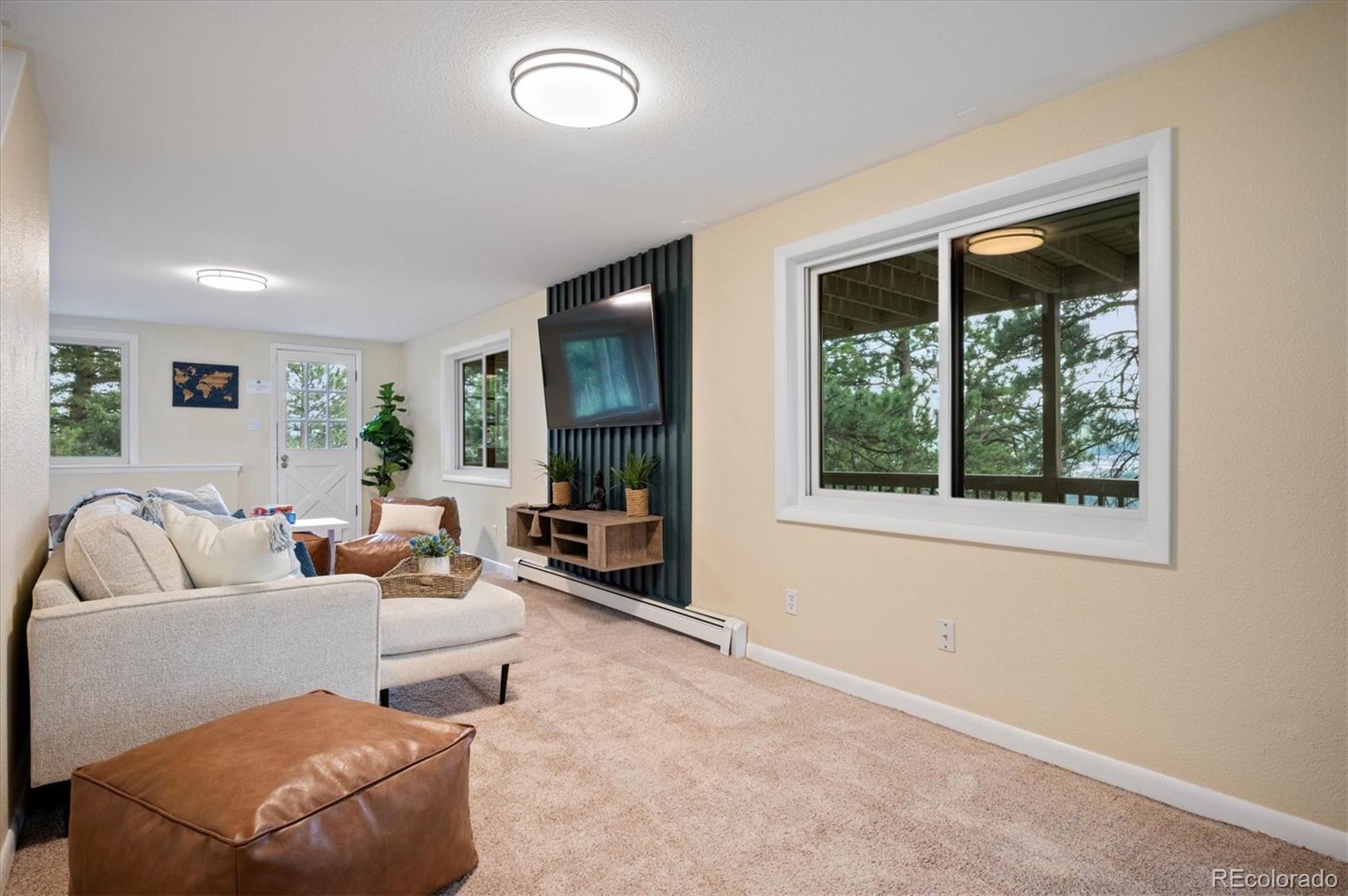 9189 Fallen Rock Road Conifer, CO 80433 - Photo 20 of 47 a living room with furniture and a large window