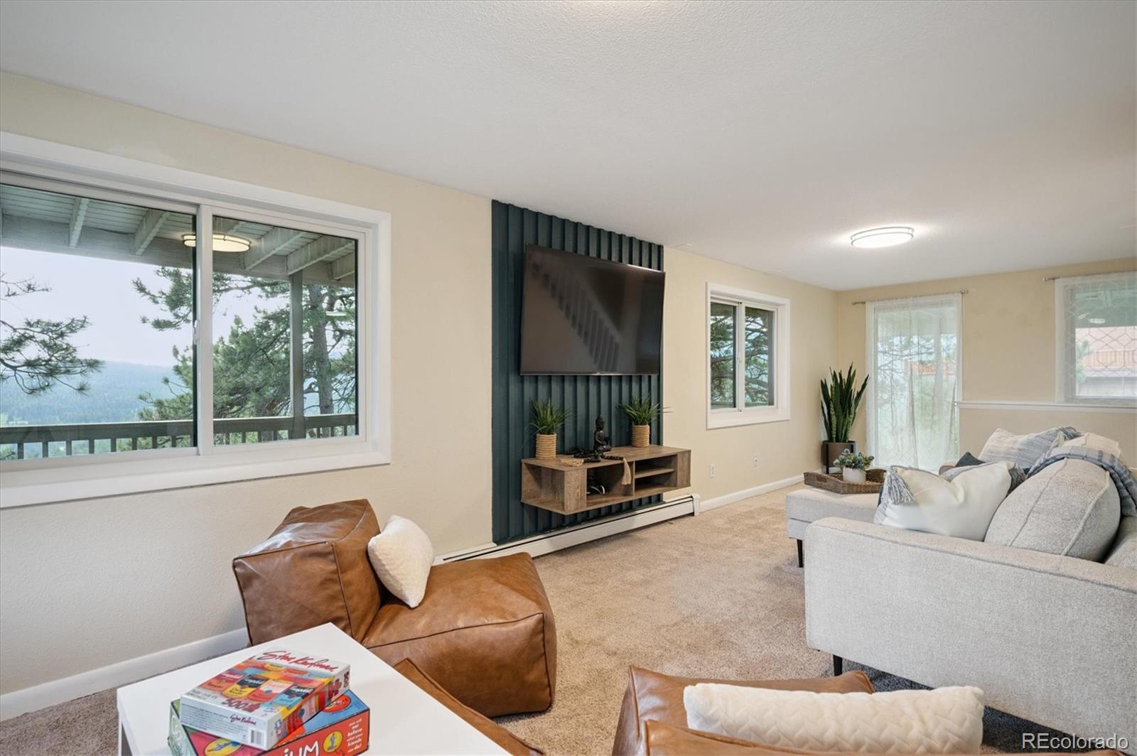 9189 Fallen Rock Road Conifer, CO 80433 - Photo 21 of 47 a living room with furniture and a window