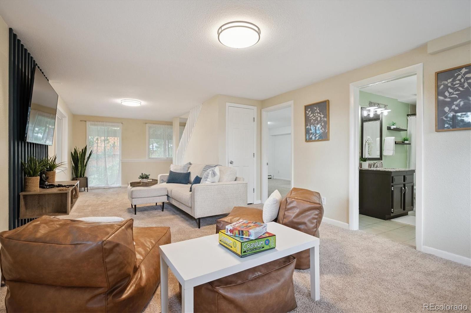 9189 Fallen Rock Road Conifer, CO 80433 - Photo 22 of 47 a living room with furniture and a flat screen tv
