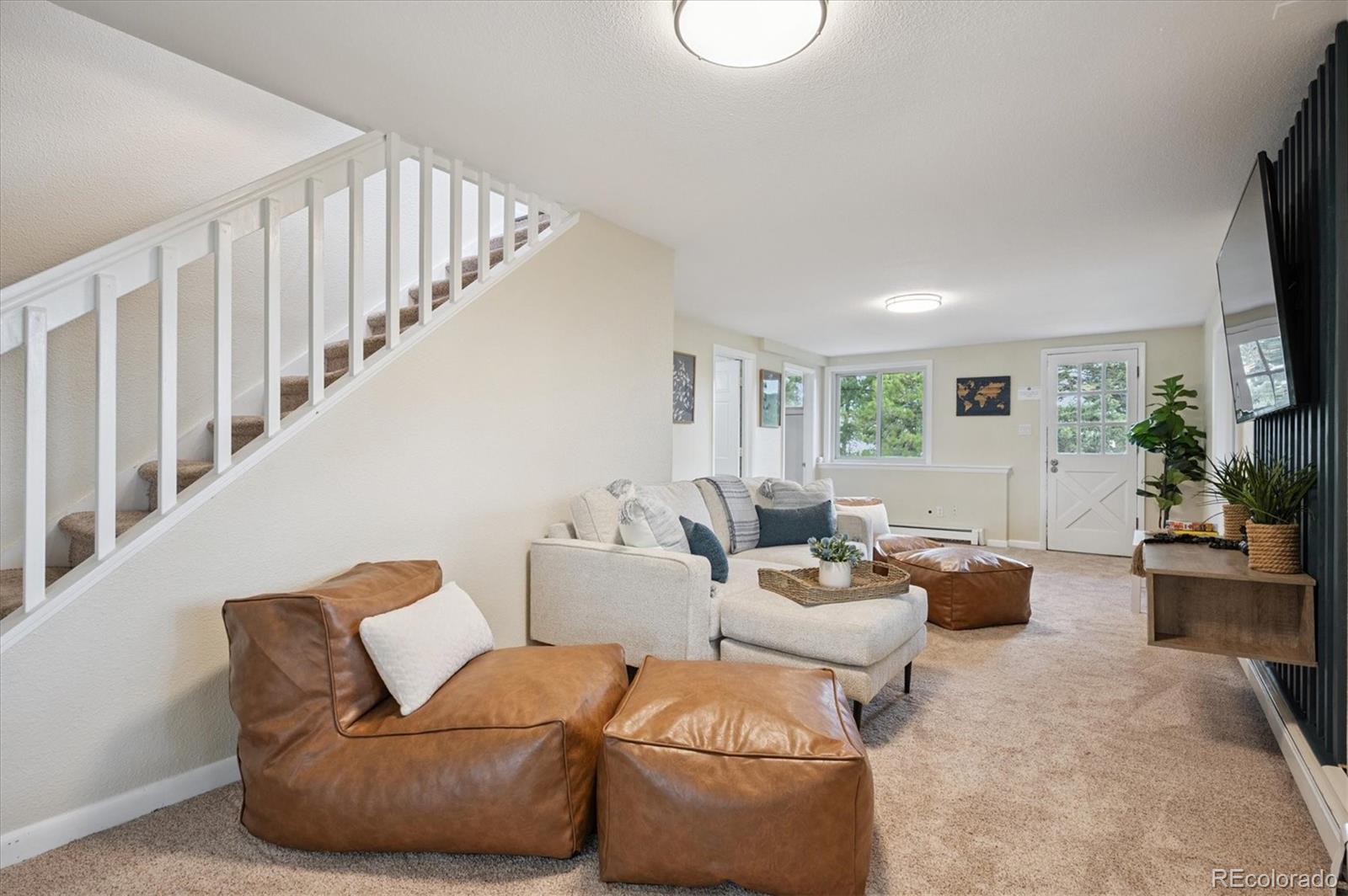 9189 Fallen Rock Road Conifer, CO 80433 - Photo 23 of 47 a living room with furniture a flat screen tv and a window