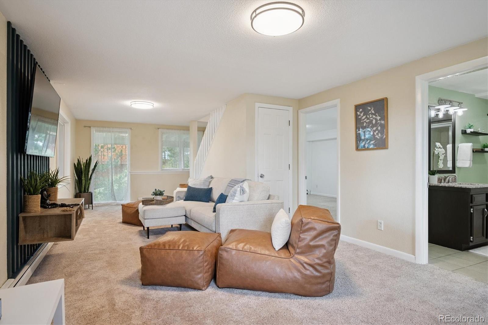 9189 Fallen Rock Road Conifer, CO 80433 - Photo 24 of 47 a living room with furniture and a flat screen tv
