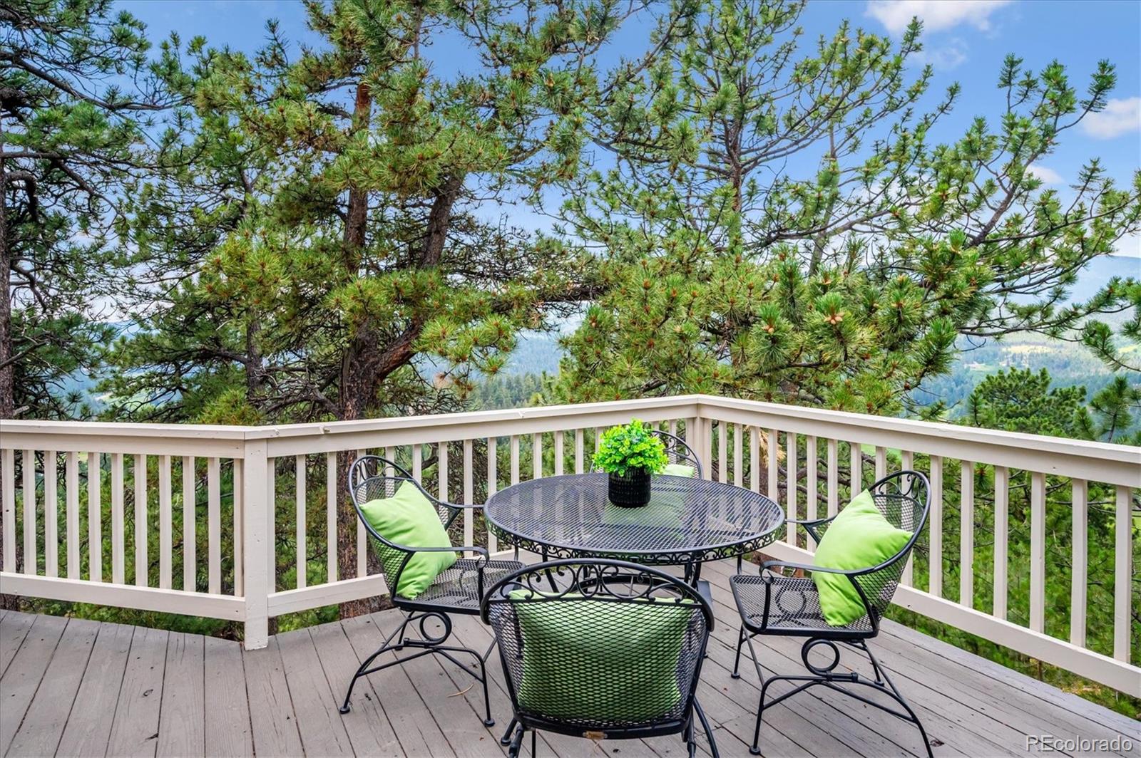 9189 Fallen Rock Road Conifer, CO 80433 - Photo 28 of 47 a view of a chair and table on the deck