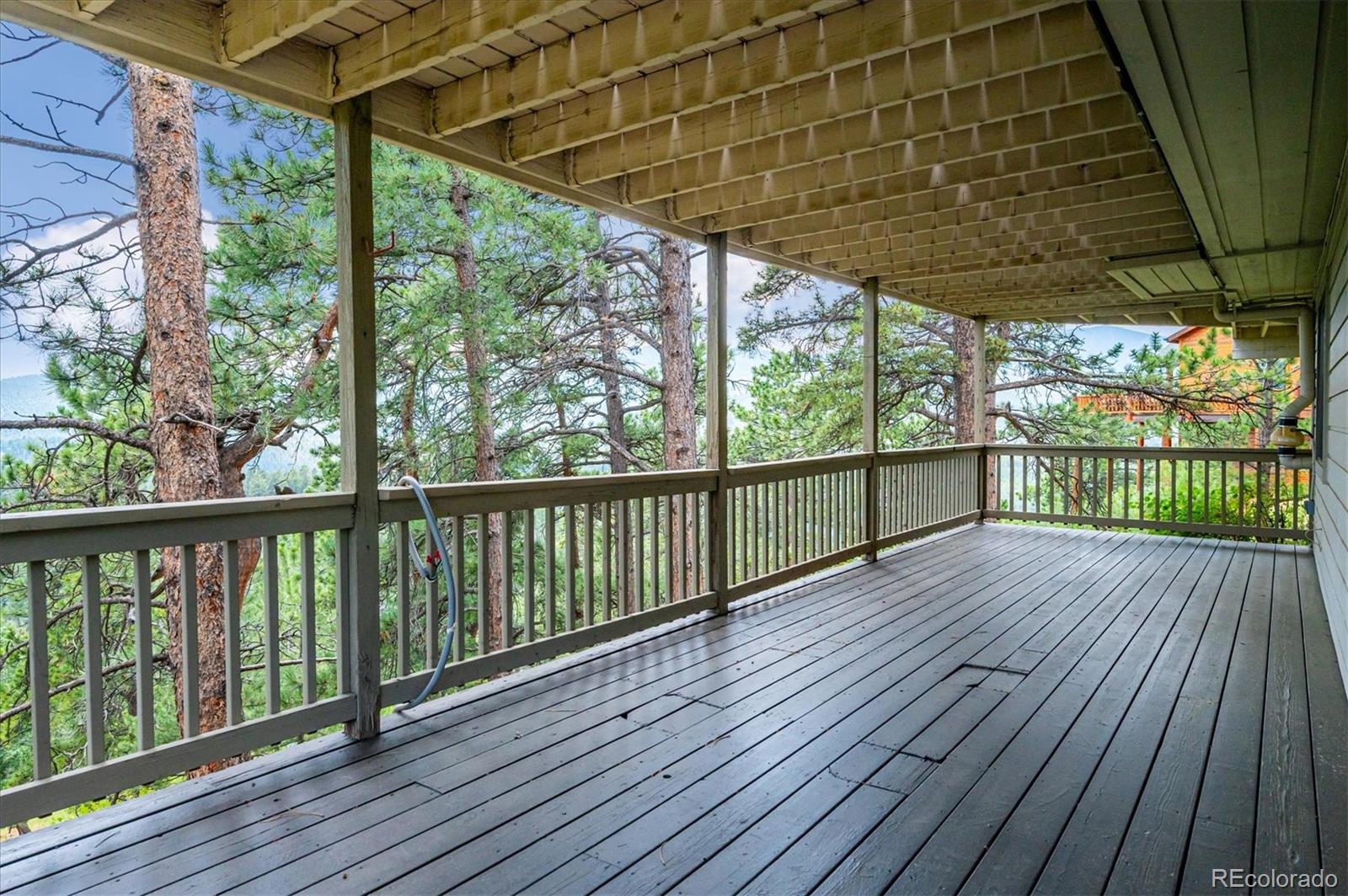 9189 Fallen Rock Road Conifer, CO 80433 - Photo 33 of 47 a view of a balcony with wooden floor