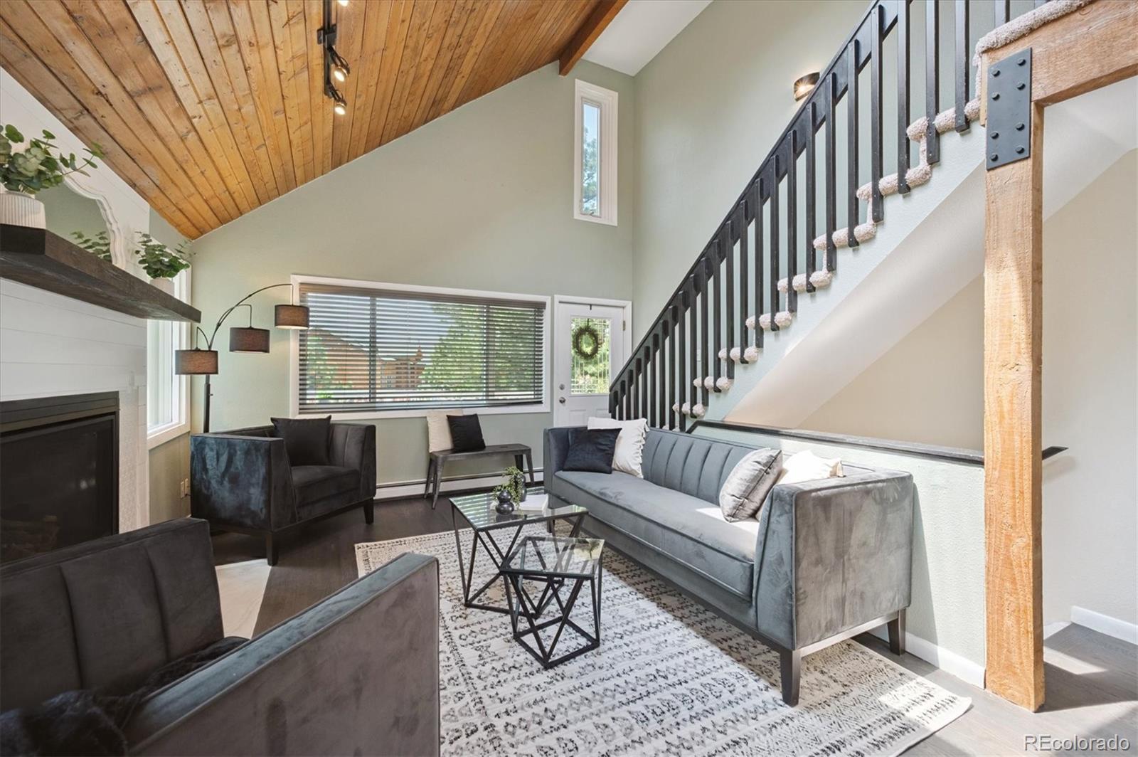 9189 Fallen Rock Road Conifer, CO 80433 - Photo 7 of 47 a living room with furniture and a large window