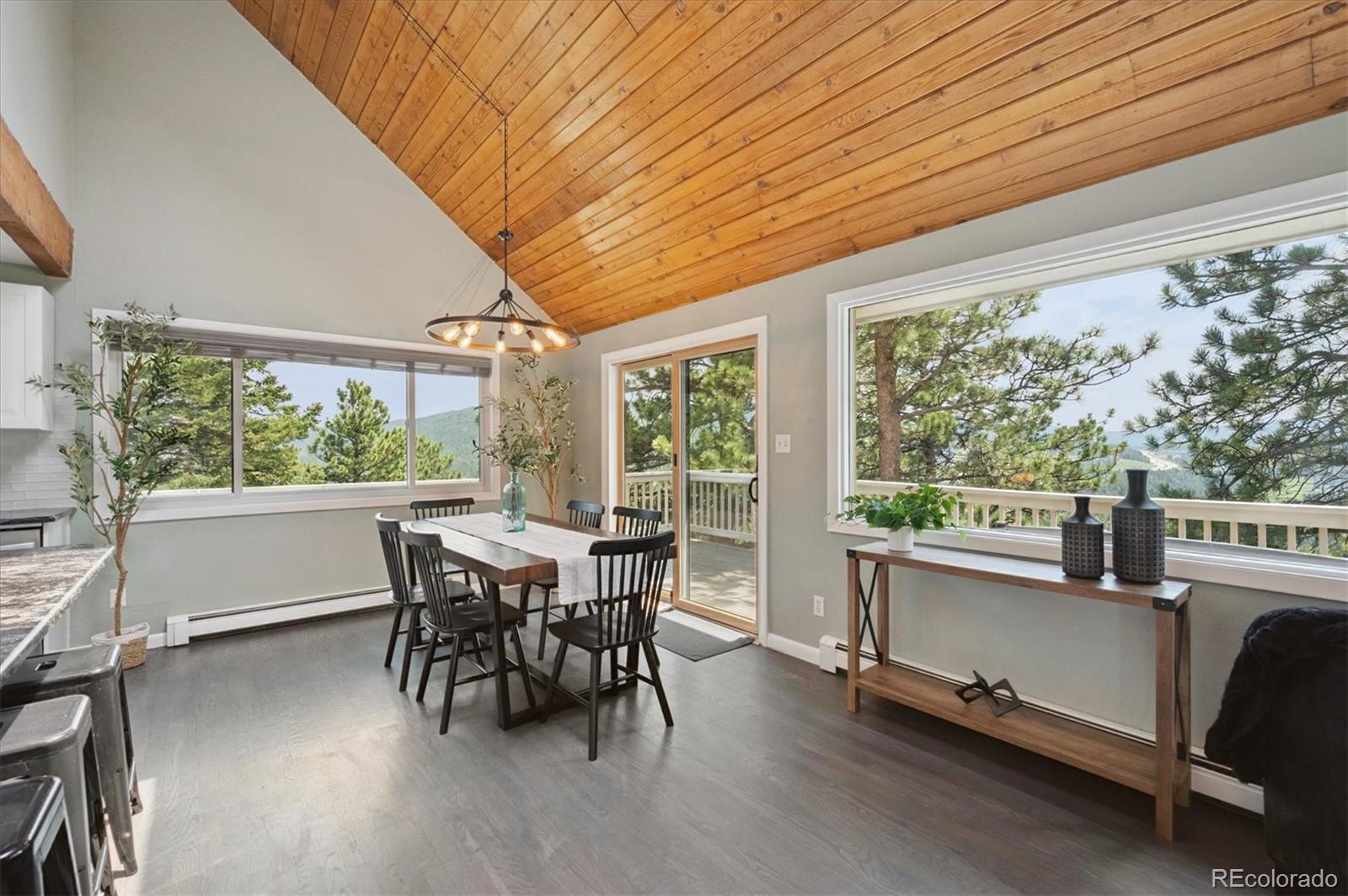 9189 Fallen Rock Road Conifer, CO 80433 - Photo 8 of 47 a view of a dining room with furniture window and outside view