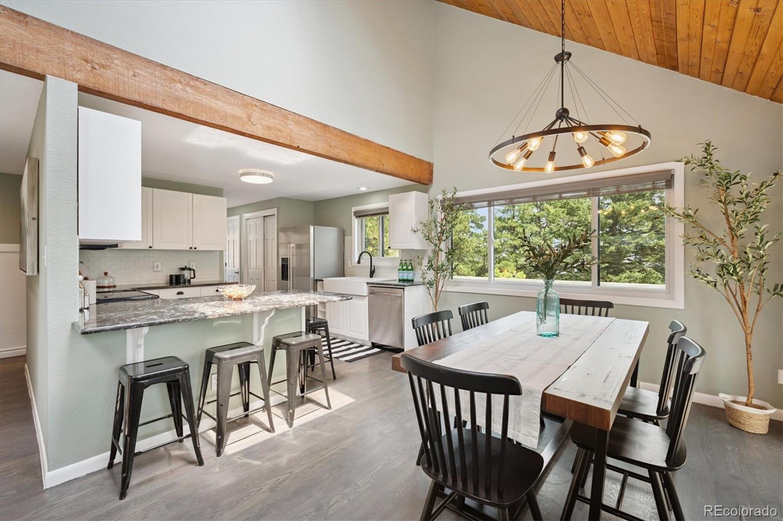 9189 Fallen Rock Road Conifer, CO 80433 - Photo 9 of 47 a view of a dining room with furniture window and outside view