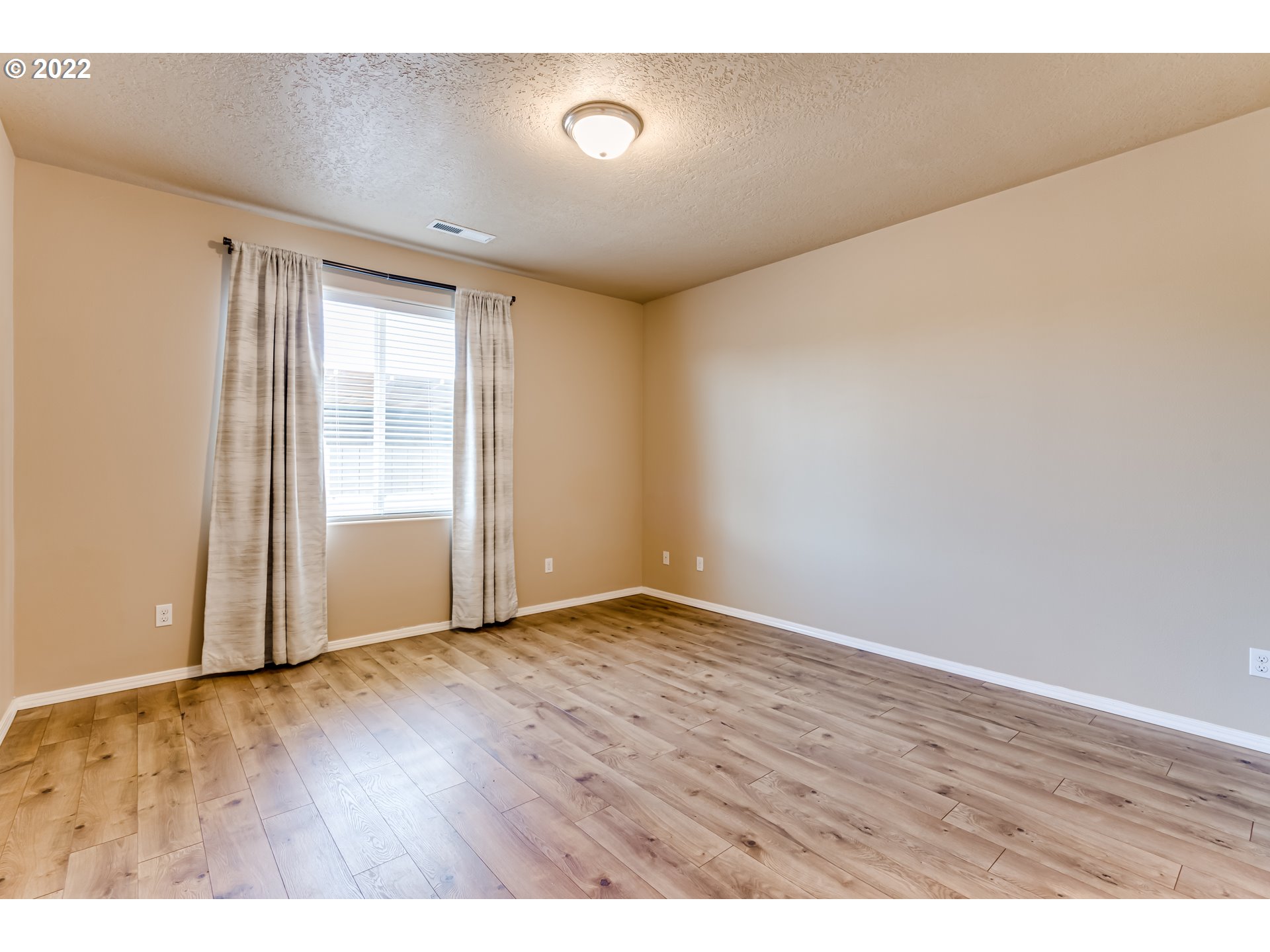 507 South 48th Place Springfield, OR 97478 - Photo 15 of 31 a view of an empty room with wooden floor