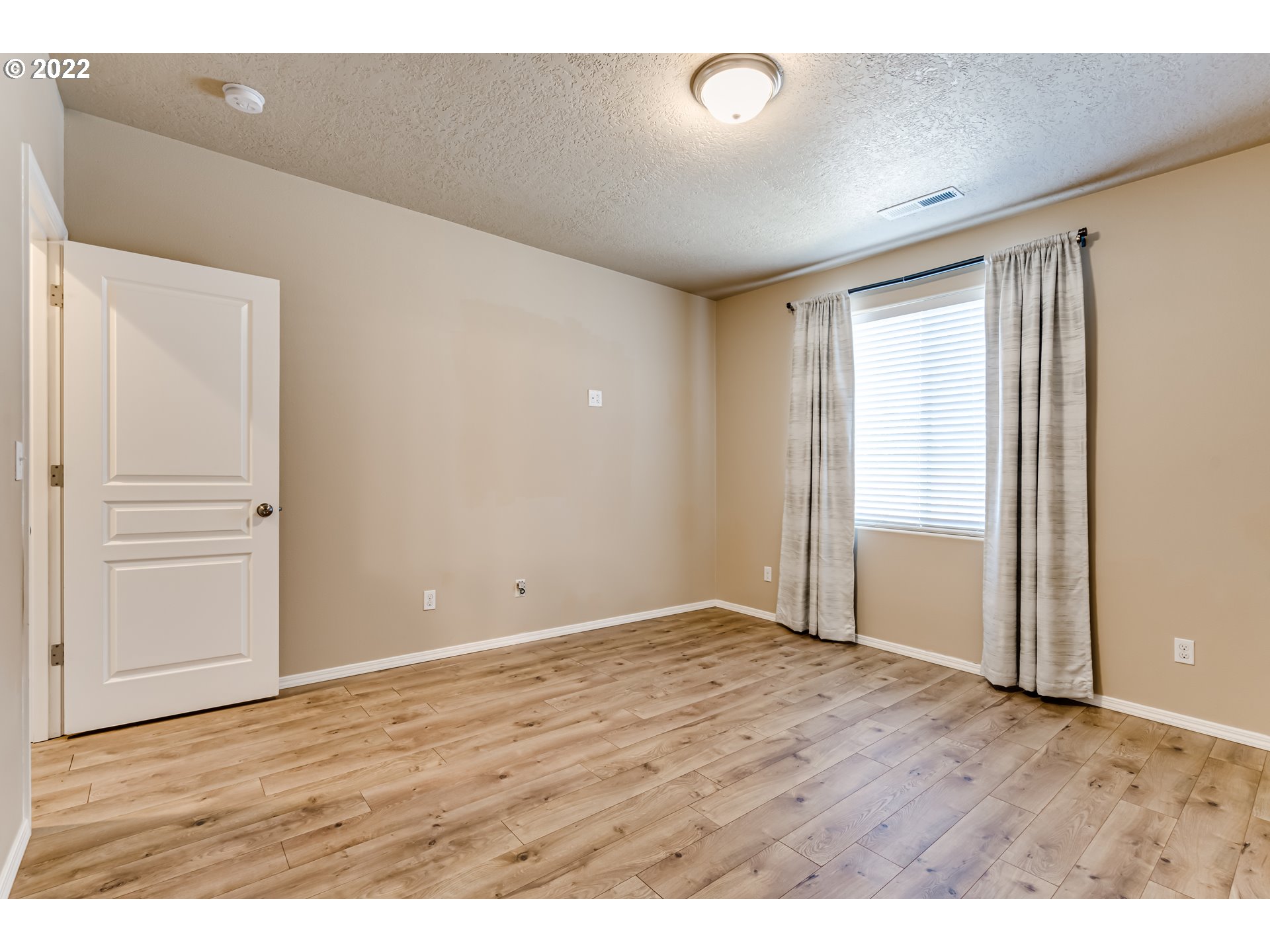507 South 48th Place Springfield, OR 97478 - Photo 16 of 31 a view of an empty room with wooden floor