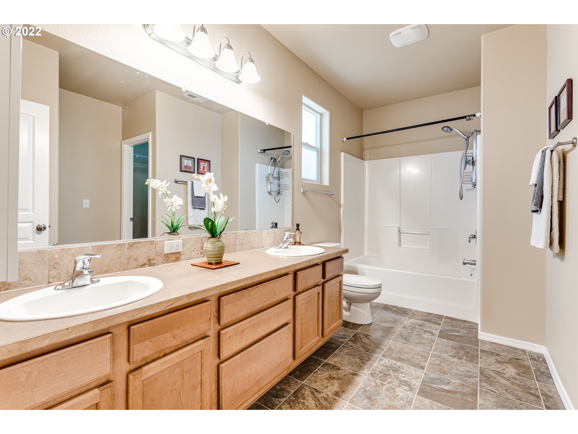507 South 48th Place Springfield, OR 97478 - Photo 18 of 31 a bathroom with a granite countertop sink toilet a large mirror a shower and vanity