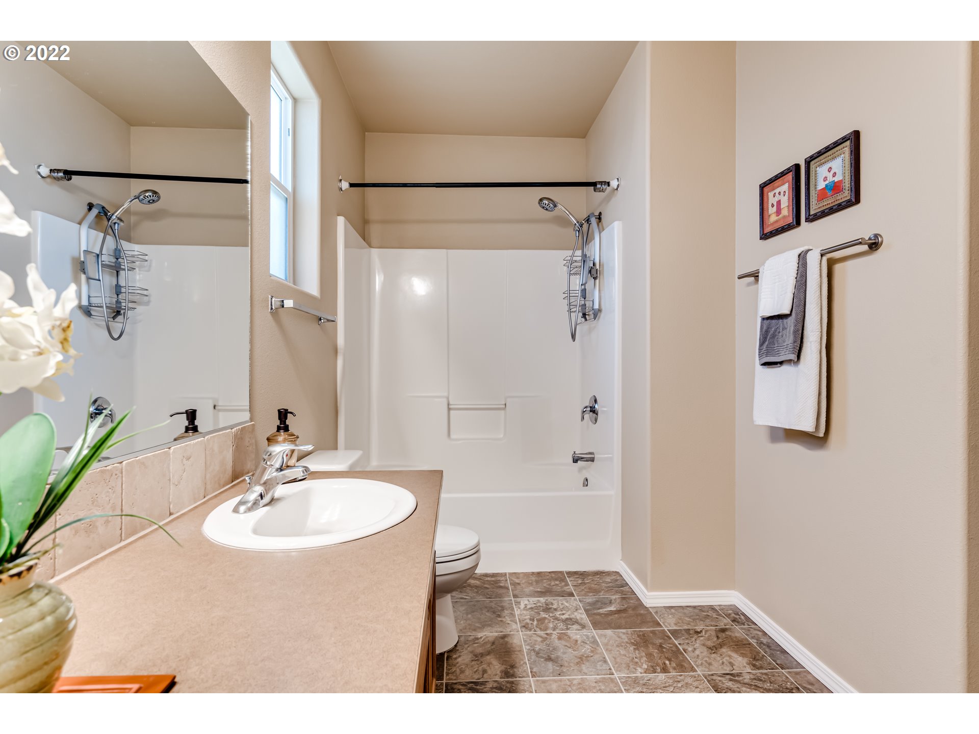 507 South 48th Place Springfield, OR 97478 - Photo 19 of 31 a bathroom with a sink a mirror and a shower