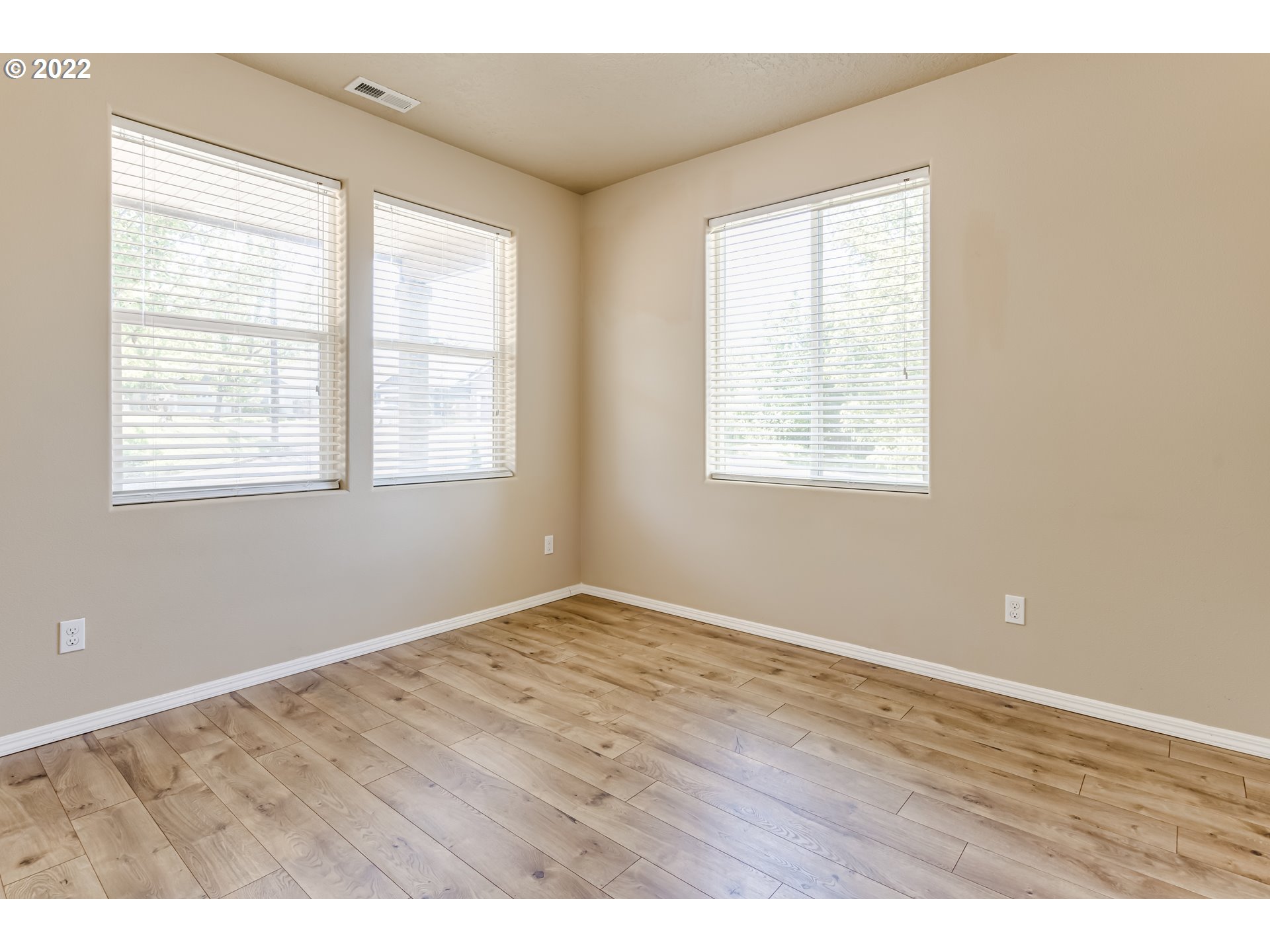 507 South 48th Place Springfield, OR 97478 - Photo 21 of 31 an empty room with wooden floor and windows