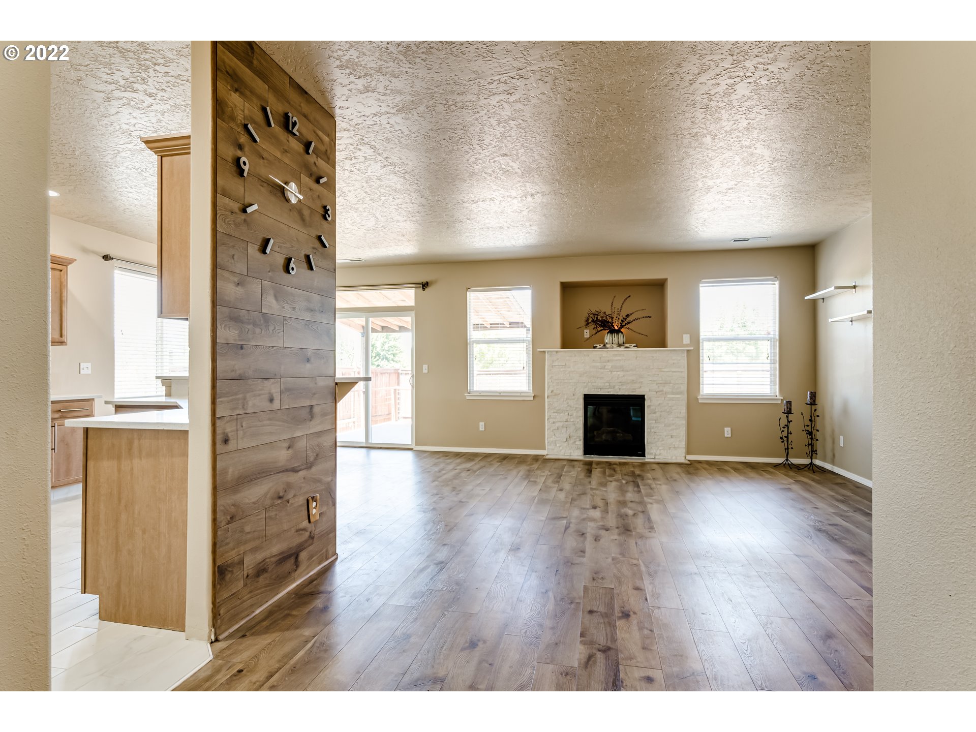 507 South 48th Place Springfield, OR 97478 - Photo 6 of 31 a view of an empty room with a fireplace and a window