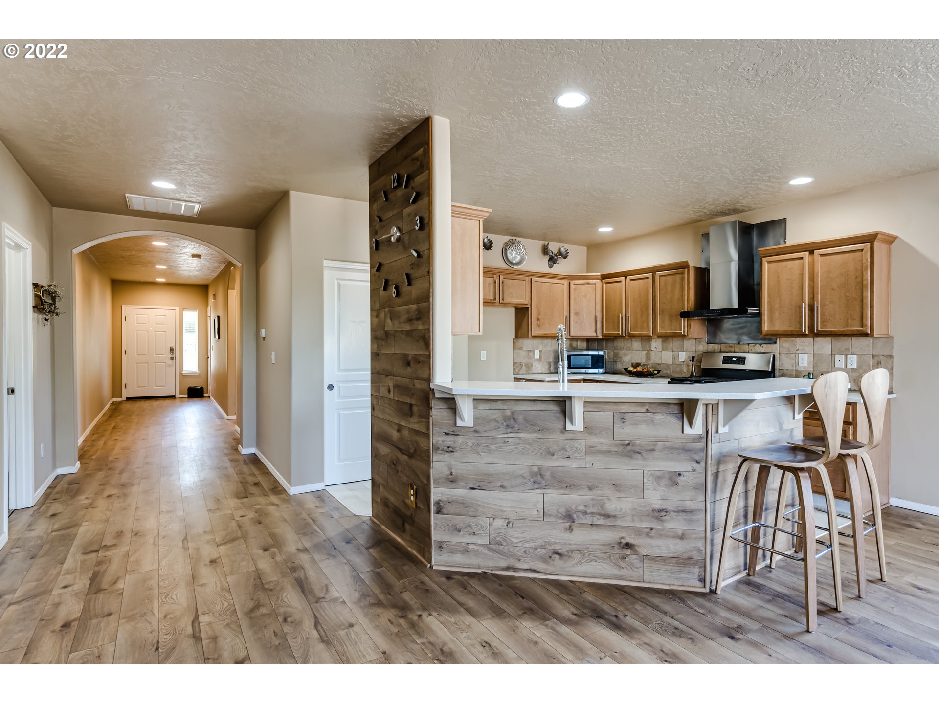 507 South 48th Place Springfield, OR 97478 - Photo 9 of 31 a kitchen with stainless steel appliances kitchen island granite countertop a refrigerator and a stove top oven