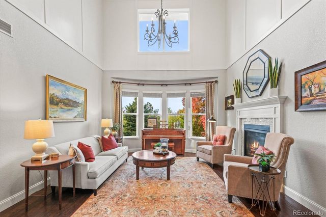 a living room with furniture a fireplace and a table
