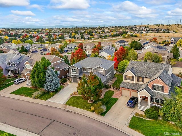 an aerial view of residential houses with outdoor space and ocean view