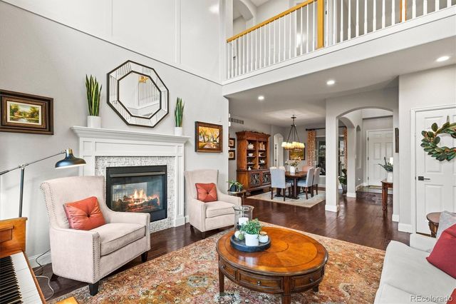 a living room with furniture a rug and a fireplace