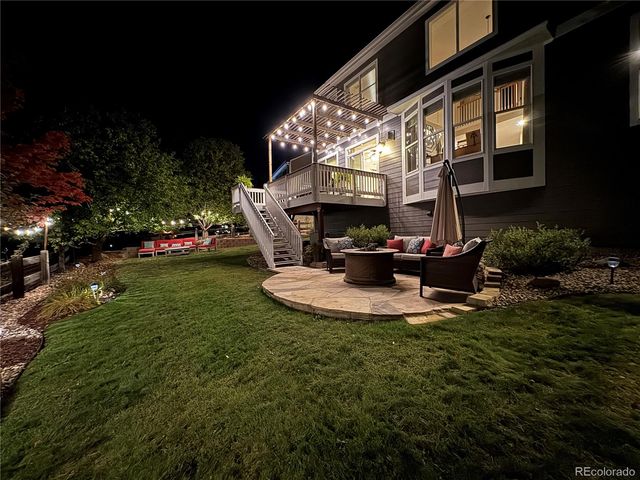 a view of a house with backyard and sitting area