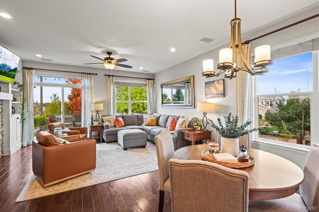 a living room with furniture potted plant and a chandelier