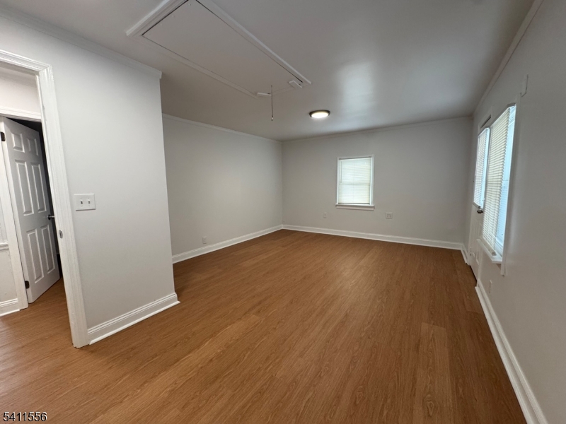 233 Franklin Road Denville, NJ 07834 - Photo 5 of 8 an empty room with wooden floor and windows
