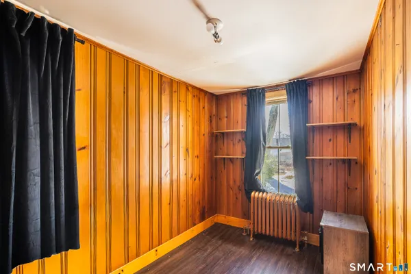 a view of a room with wooden floor and furniture