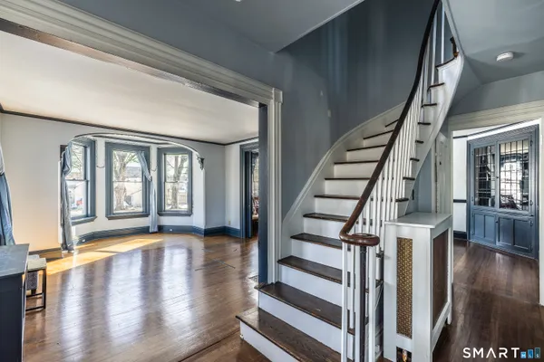 a view of an entryway with wooden floor and door