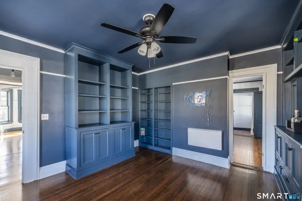 a view of a hallway with wooden floor and closet