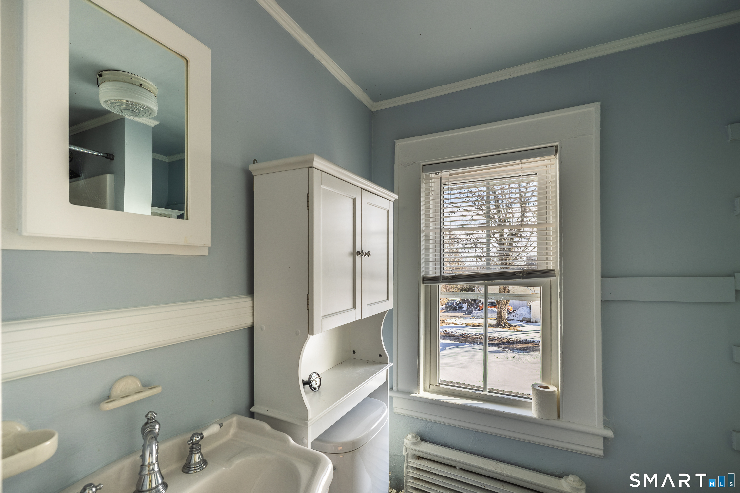 5385 Main Street Trumbull, CT 06611 - Photo 18 of 39 a bathroom with a sink a toilet and a window
