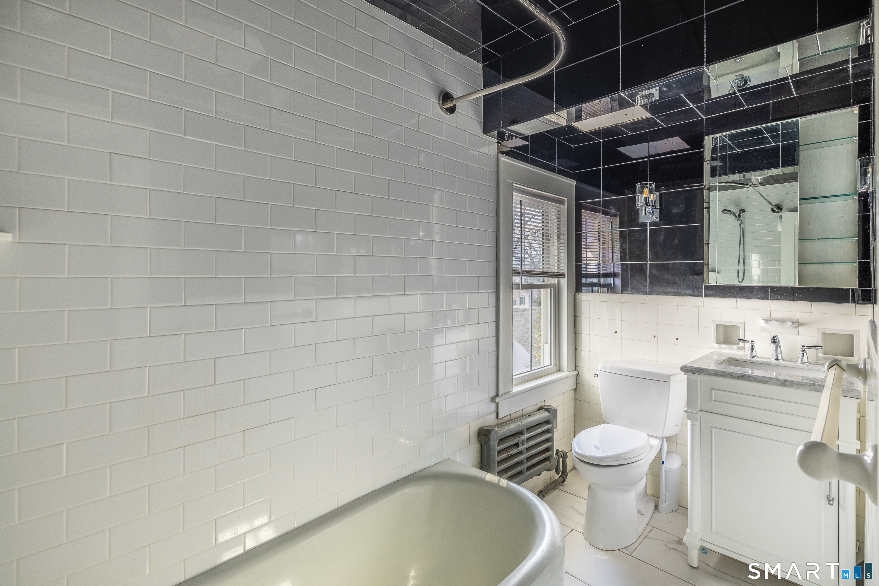 5385 Main Street Trumbull, CT 06611 - Photo 26 of 39 a bathroom with a sink a toilet and shower