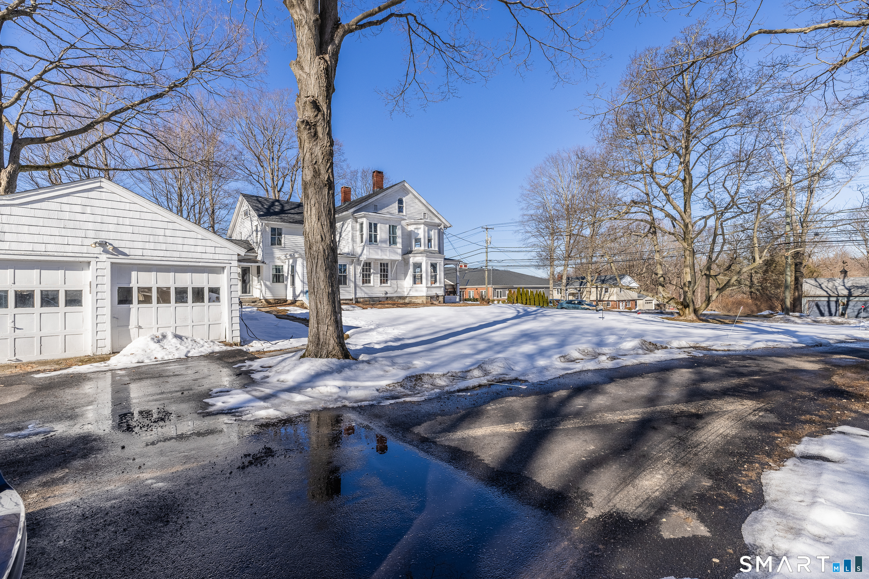 5385 Main Street Trumbull, CT 06611 - Photo 30 of 39 a view of residential houses with snow on the road