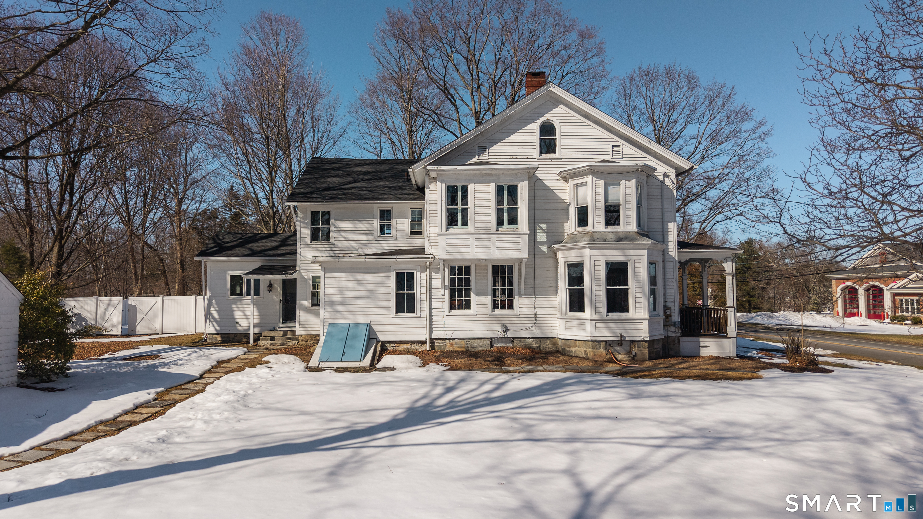5385 Main Street Trumbull, CT 06611 - Photo 32 of 39 a view of a white house with large windows next to a road