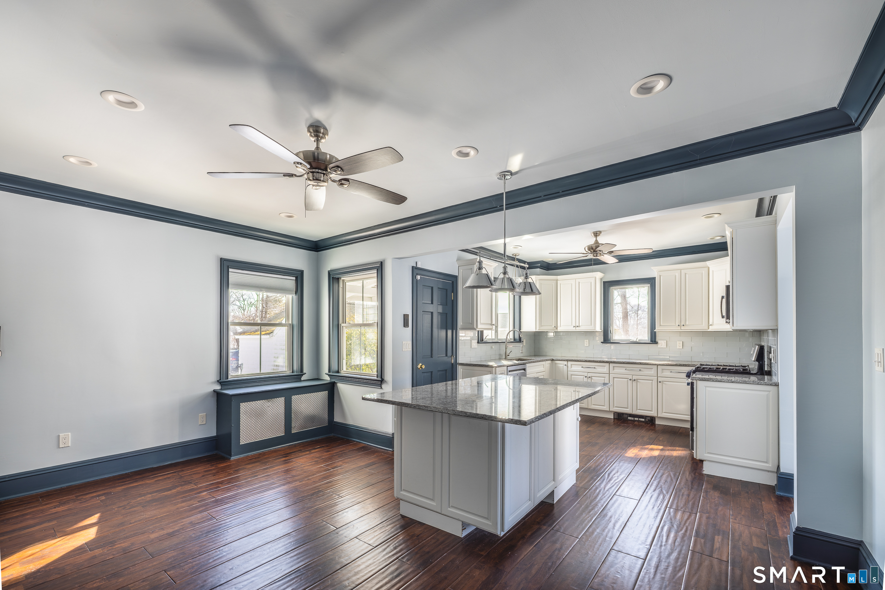 5385 Main Street Trumbull, CT 06611 - Photo 5 of 39 a open kitchen with white cabinets and wooden floor