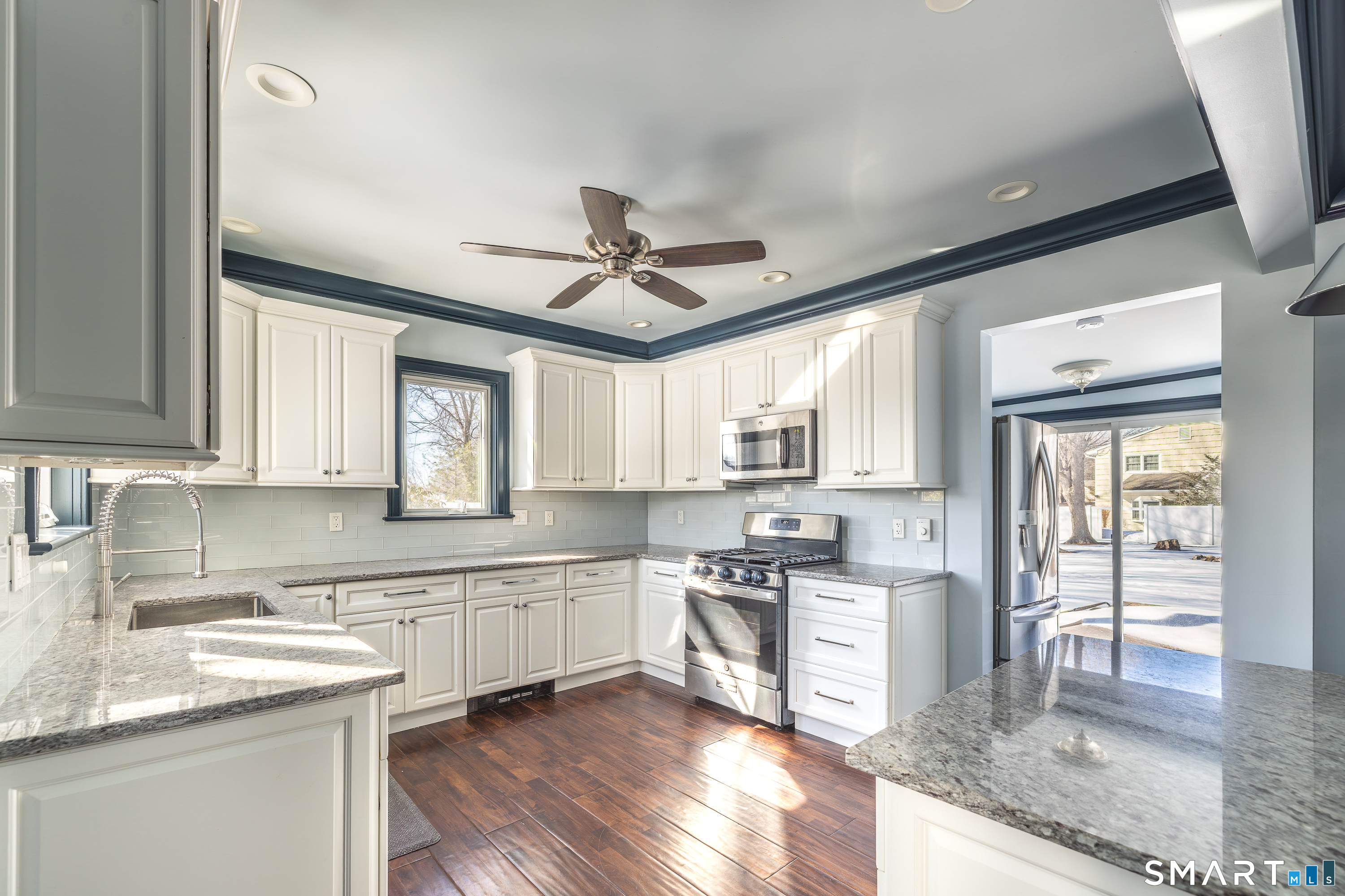 5385 Main Street Trumbull, CT 06611 - Photo 6 of 39 a kitchen with stainless steel appliances granite countertop a sink stove and cabinets