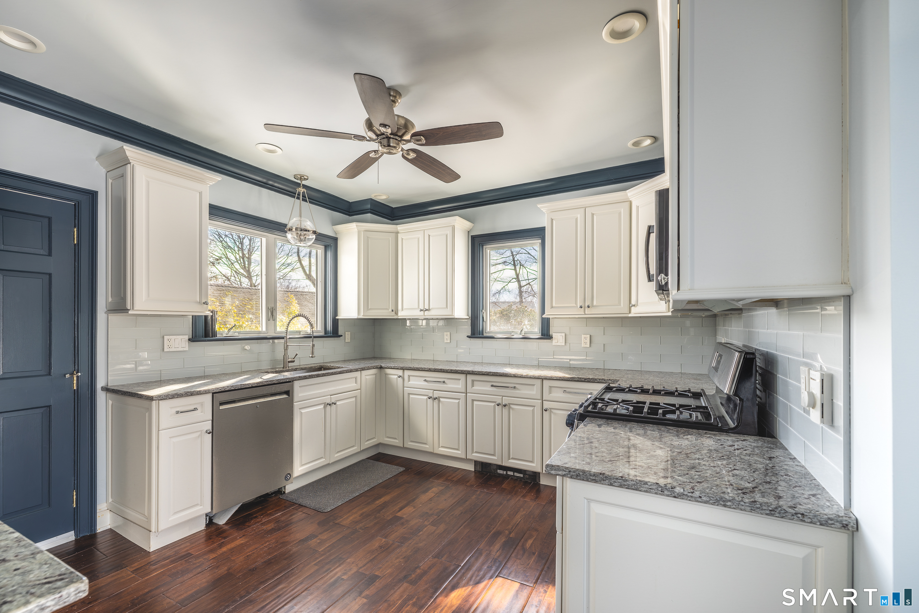 5385 Main Street Trumbull, CT 06611 - Photo 7 of 39 a kitchen with stainless steel appliances granite countertop a sink and cabinets