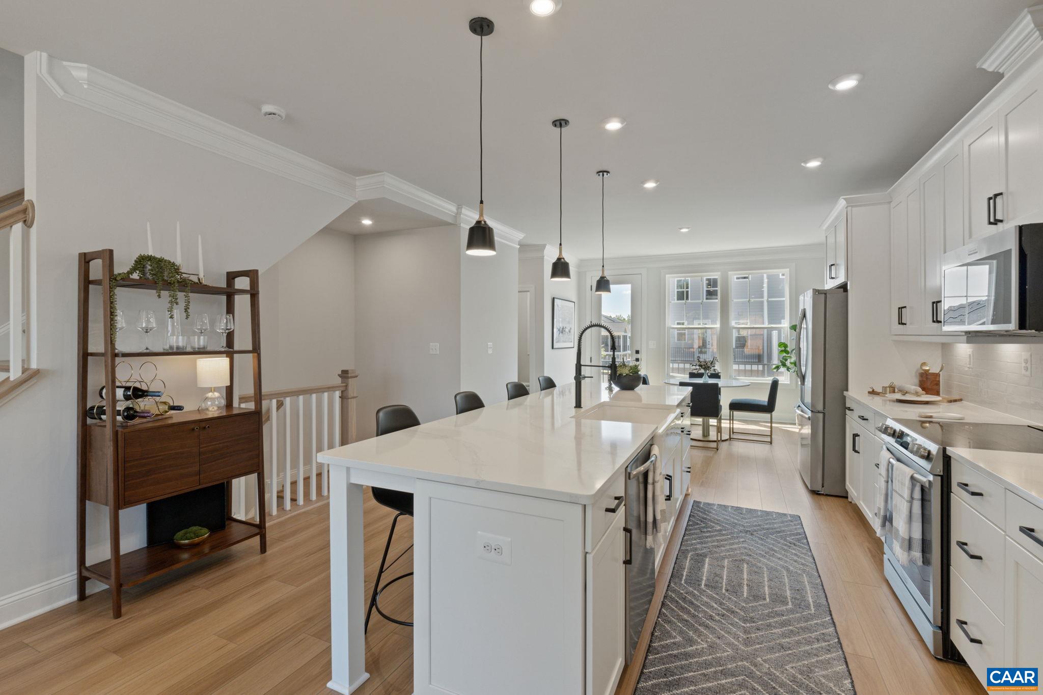 5012 Lindley Place Charlottesville, VA 22901 - Photo 7 of 39 a kitchen with sink a refrigerator and chairs