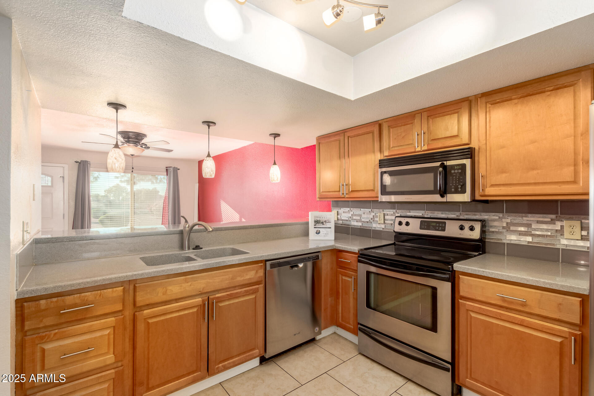 19601 North 7th Street, Unit 1063 Phoenix, AZ 85024 - Photo 11 of 26 a kitchen with stainless steel appliances a sink cabinets and a stove top oven