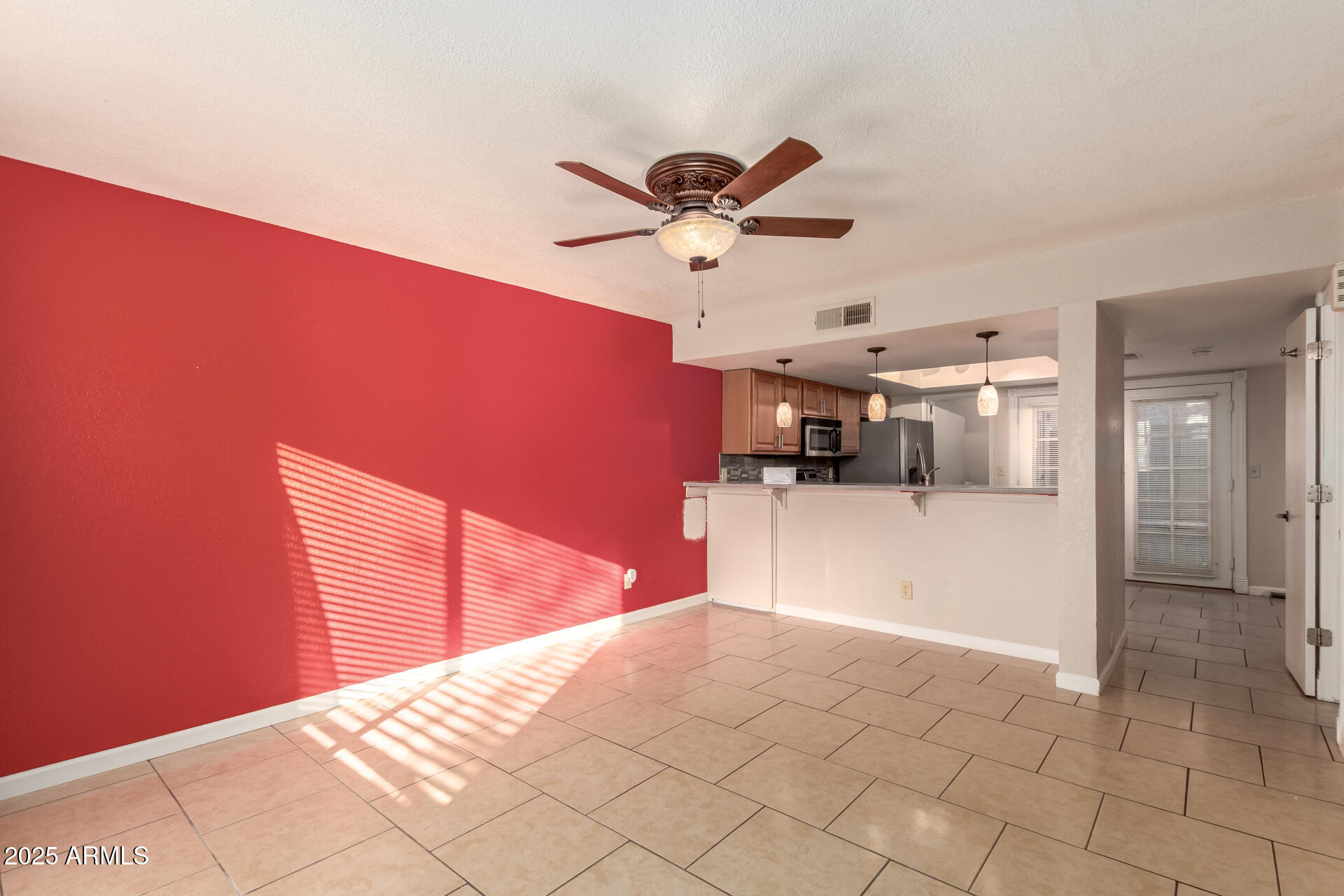 19601 North 7th Street, Unit 1063 Phoenix, AZ 85024 - Photo 4 of 26 a bedroom with a bed and a chandelier