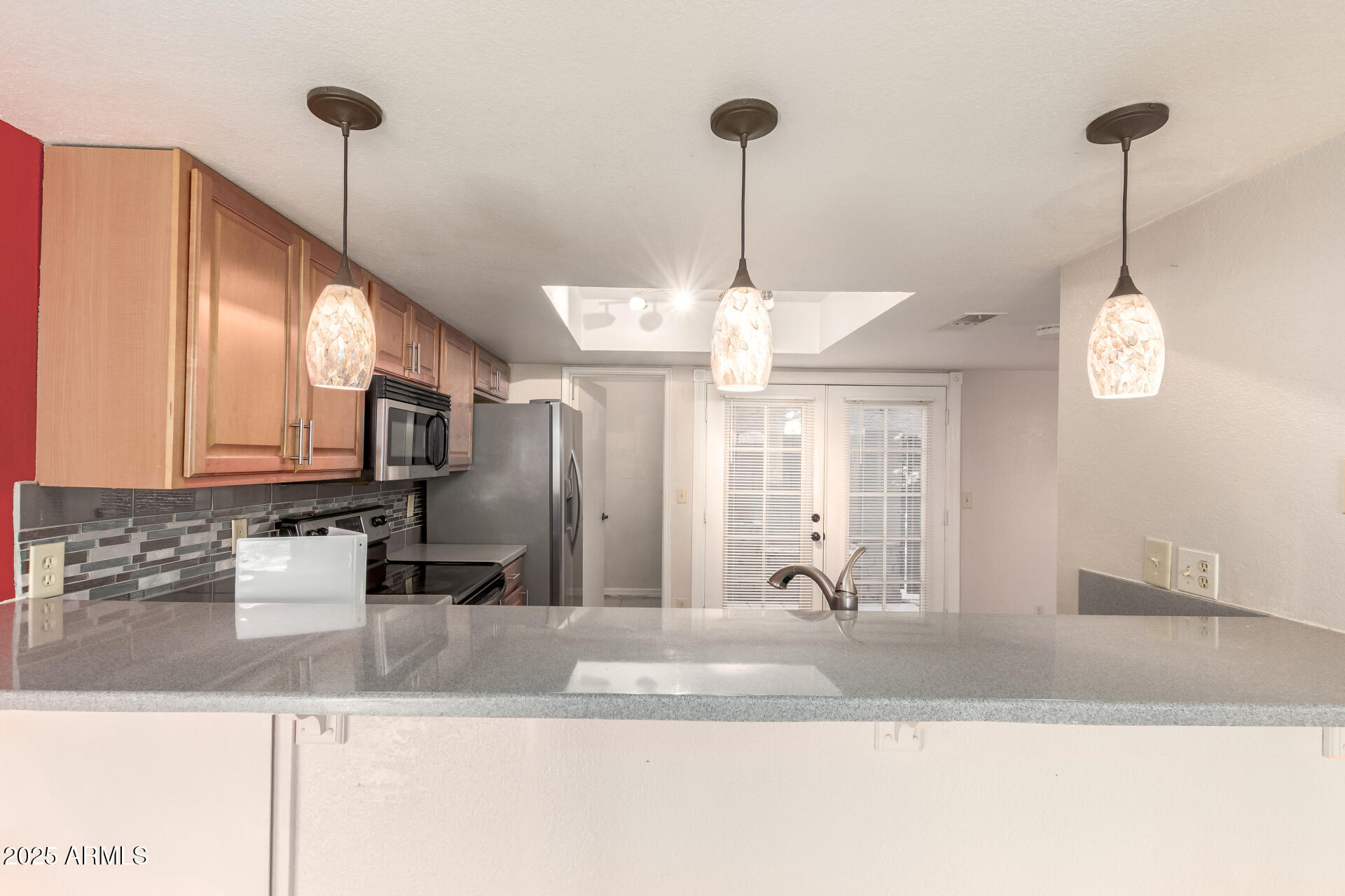 19601 North 7th Street, Unit 1063 Phoenix, AZ 85024 - Photo 8 of 26 a view of a kitchen with stainless steel appliances granite countertop a sink a refrigerator a stove and a kitchen island