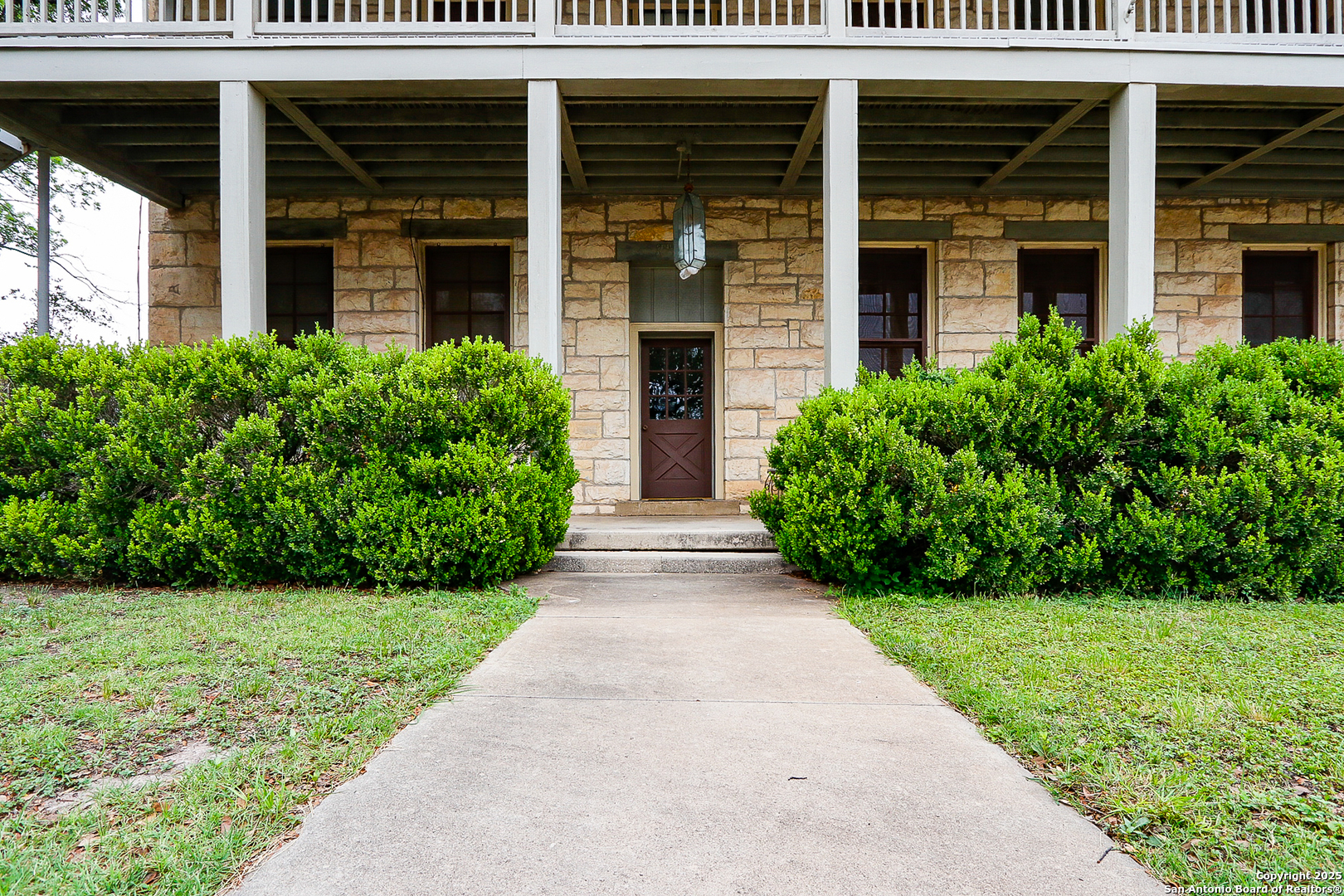 a view of brick house with a yard