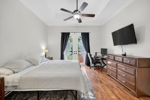 a bedroom with a bed and a flat screen tv