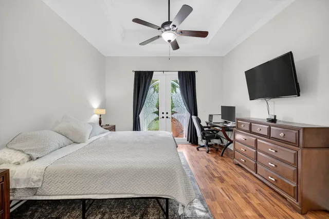 a bedroom with a bed and a flat screen tv