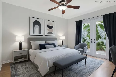 a bedroom with a bed and a flat screen tv