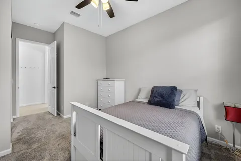a bedroom with a bed and a ceiling fan