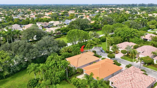 an aerial view of residential houses with outdoor space and trees