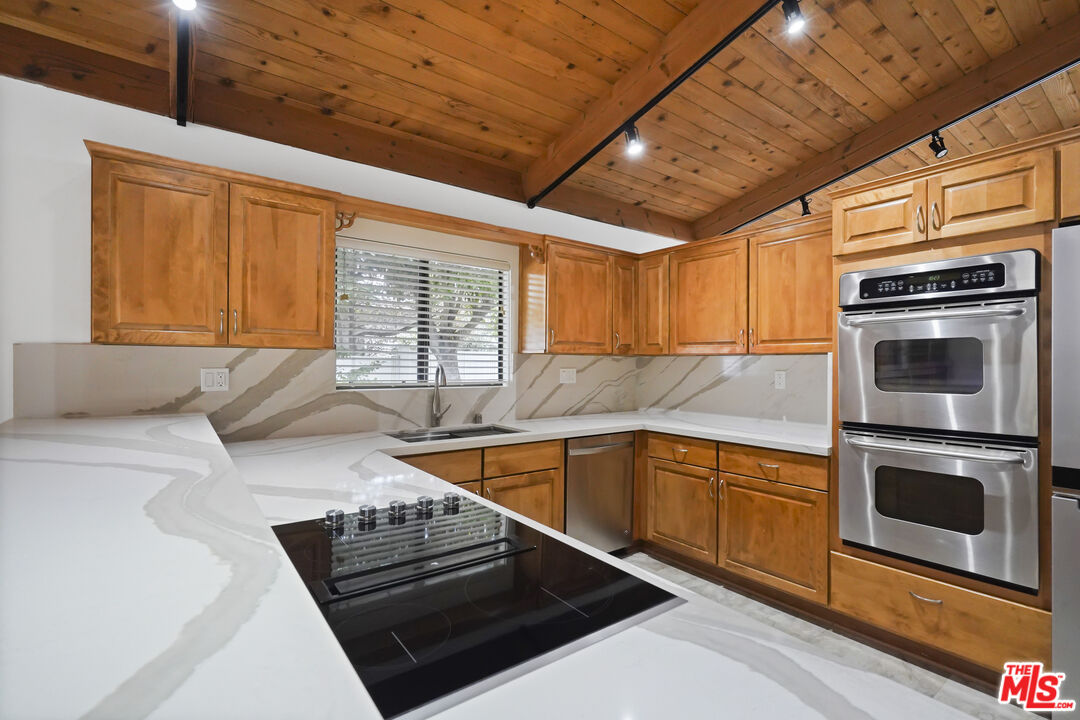 Sea Star Drive Malibu, CA 90265 - Photo 15 of 33 a kitchen with stainless steel appliances a stove sink and microwave