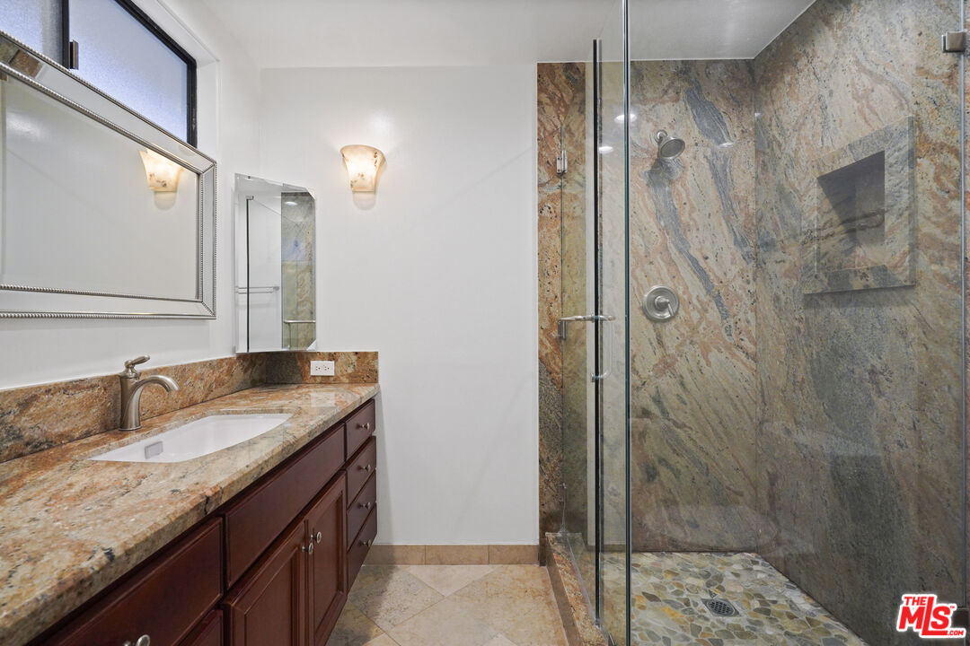 Sea Star Drive Malibu, CA 90265 - Photo 23 of 33 a bathroom with a granite countertop sink a mirror and shower