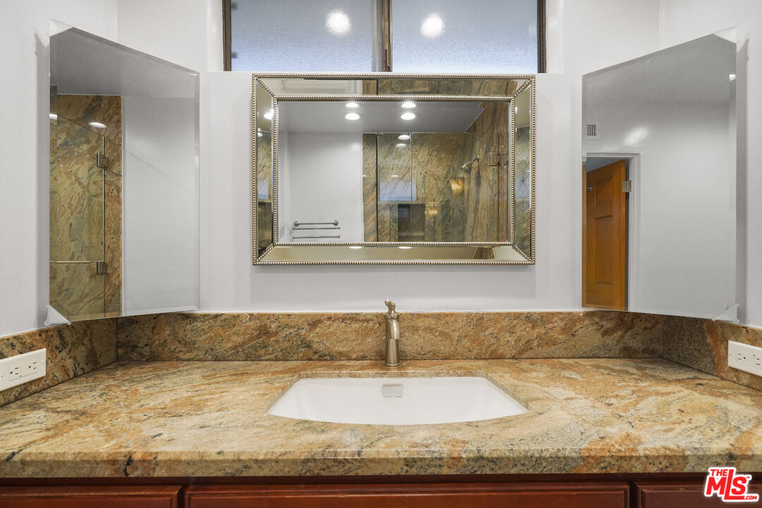Sea Star Drive Malibu, CA 90265 - Photo 24 of 33 a bathroom with a granite countertop sink and mirror