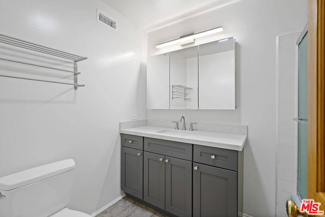 Sea Star Drive Malibu, CA 90265 - Photo 29 of 33 a bathroom with a toilet a sink a vanity and mirror