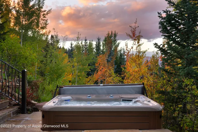 a view of a two chairs in the backyard of a house